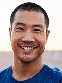 man smiling while taking selfie 